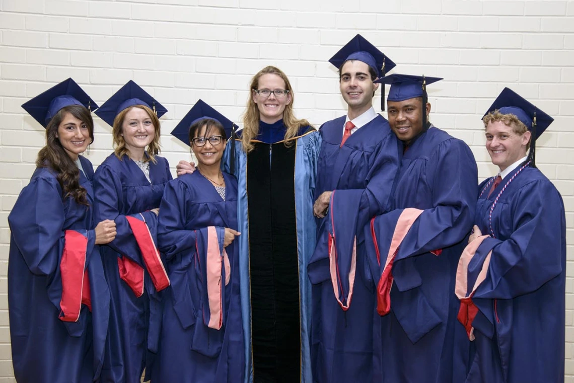 Kacey Ernst, PhD, MPH, poses with students at the 2014 convocation. 