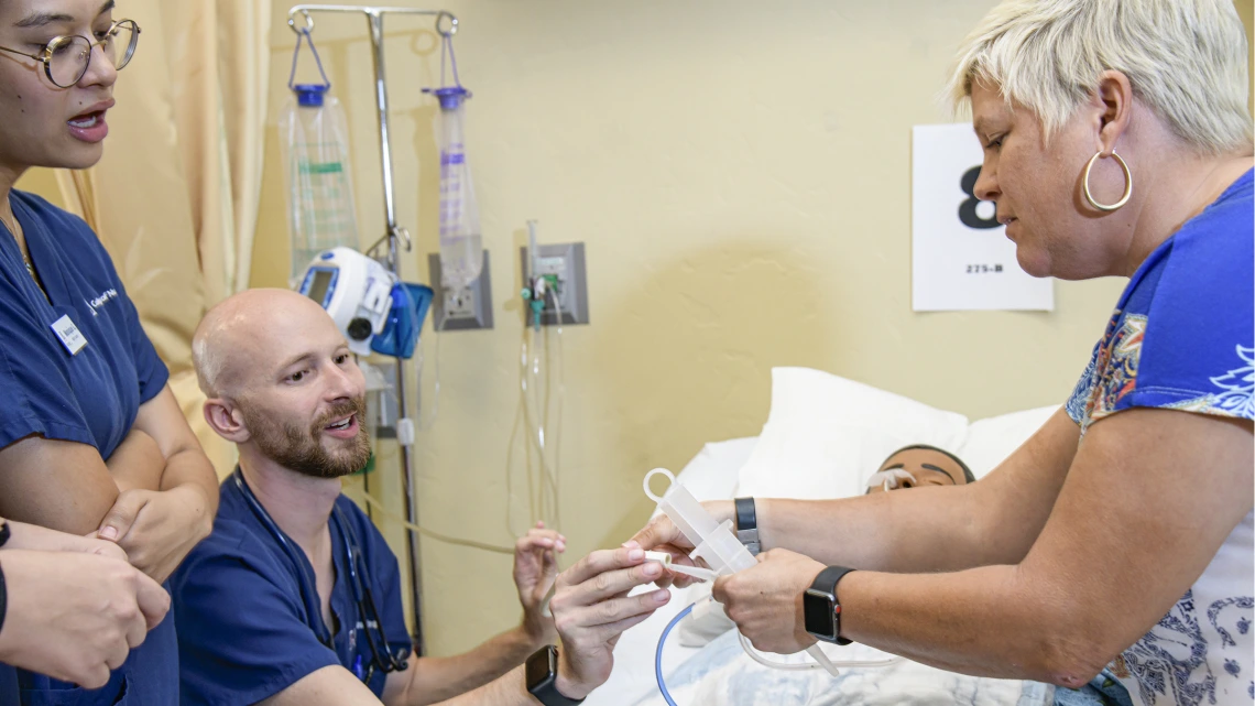 A recent physiology graduate, Nick Knapton (center) studies nursing at the University of Arizona.