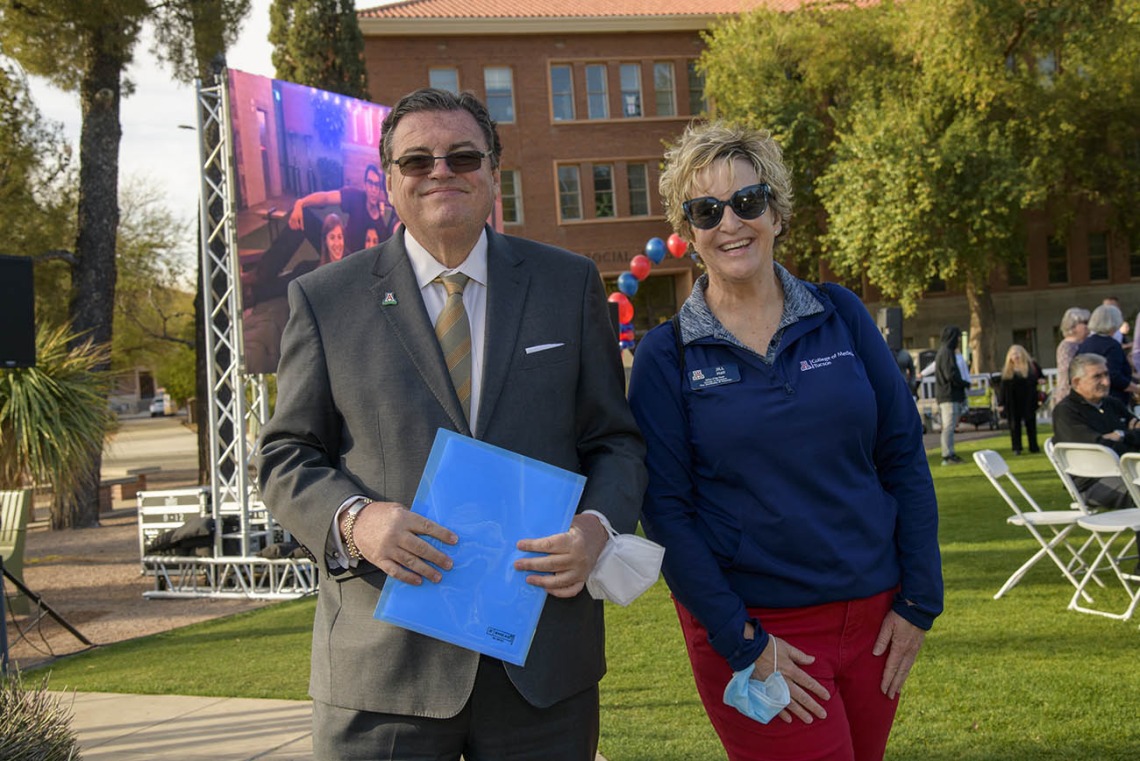 Michael Abecassis, MD, MBA, dean of the UArizona College of Medicine – Tucson, and Jill Hall, manager, alumni and community engagement, enjoy the festive surroundings at the UArizona College of Medicine – Tucson 2022 Match Day event.