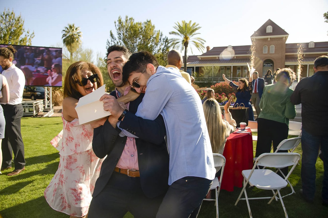 Aaron Masjedi is sandwich-hugged by his mother, Shiva Mahboob, and younger brother Eli Masjedi, after finding out he was matched with the University of Southern California during the UArizona College of Medicine – Tucson 2022 Match Day event on the lawn west of Old Main.