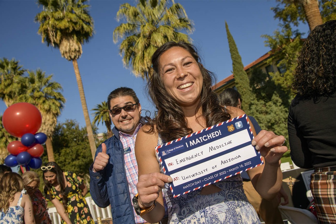 Brianna Dolana holds up her match sign showing that she matched in emergency medicine at the University of Arizona – Tucson during the UArizona College of Medicine – Tucson 2022 Match Day event. 