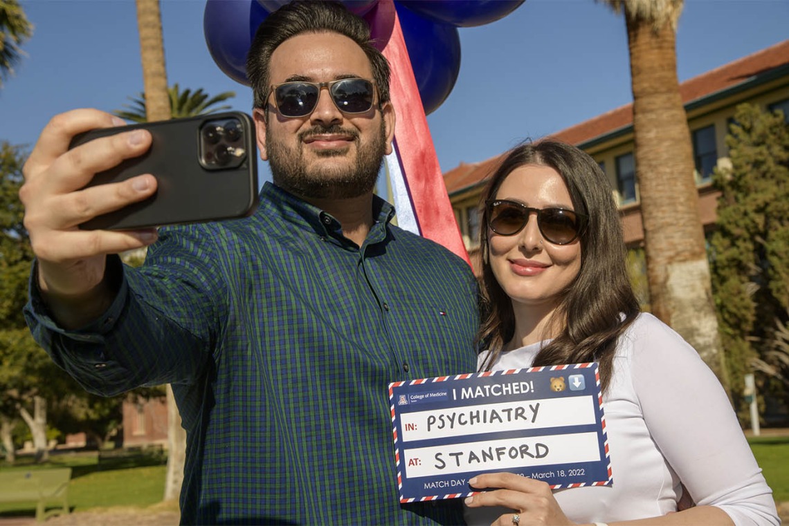 Mohammad Mojadidi and his fiancé Madina Jahed snap a selfie as Jahed shows her match to Stanford during the UArizona College of Medicine – Tucson 2022 Match Day event.