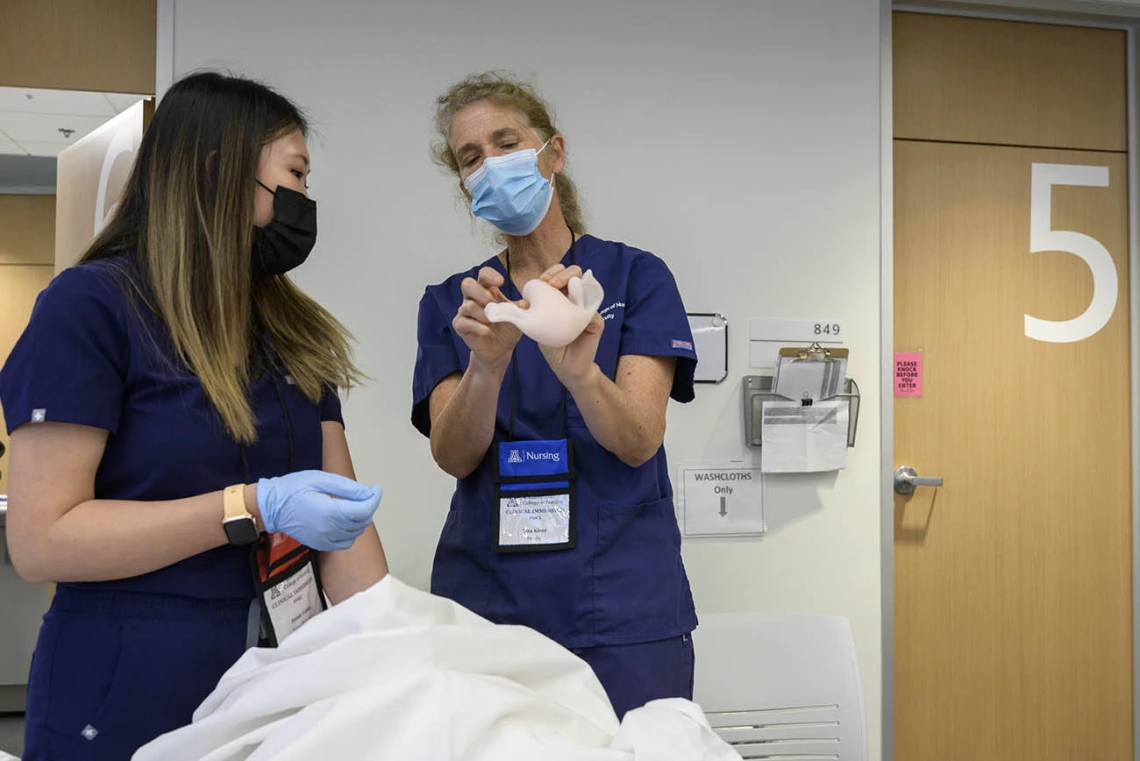 A UArizona College of Nursing professor explains the position of the uterus in the pelvis with a Doctor of Nursing Practice – Nurse-Midwifery student.