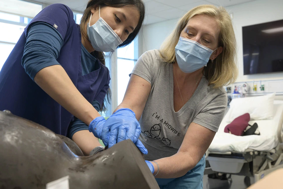 UArizona College of Nursing Doctor of Nursing Practice nurse-midwifery student learns how to guide a baby out of the birth canal.