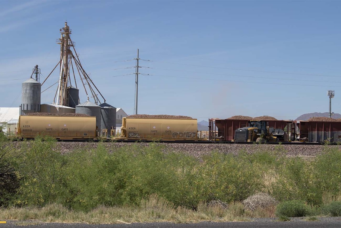 A train hauls grain by a farm near the community center in Aguila, Arizona, the site of a MOVE UP clinic to get COVID-19 vaccines to hard-to-reach rural and underrepresented populations.