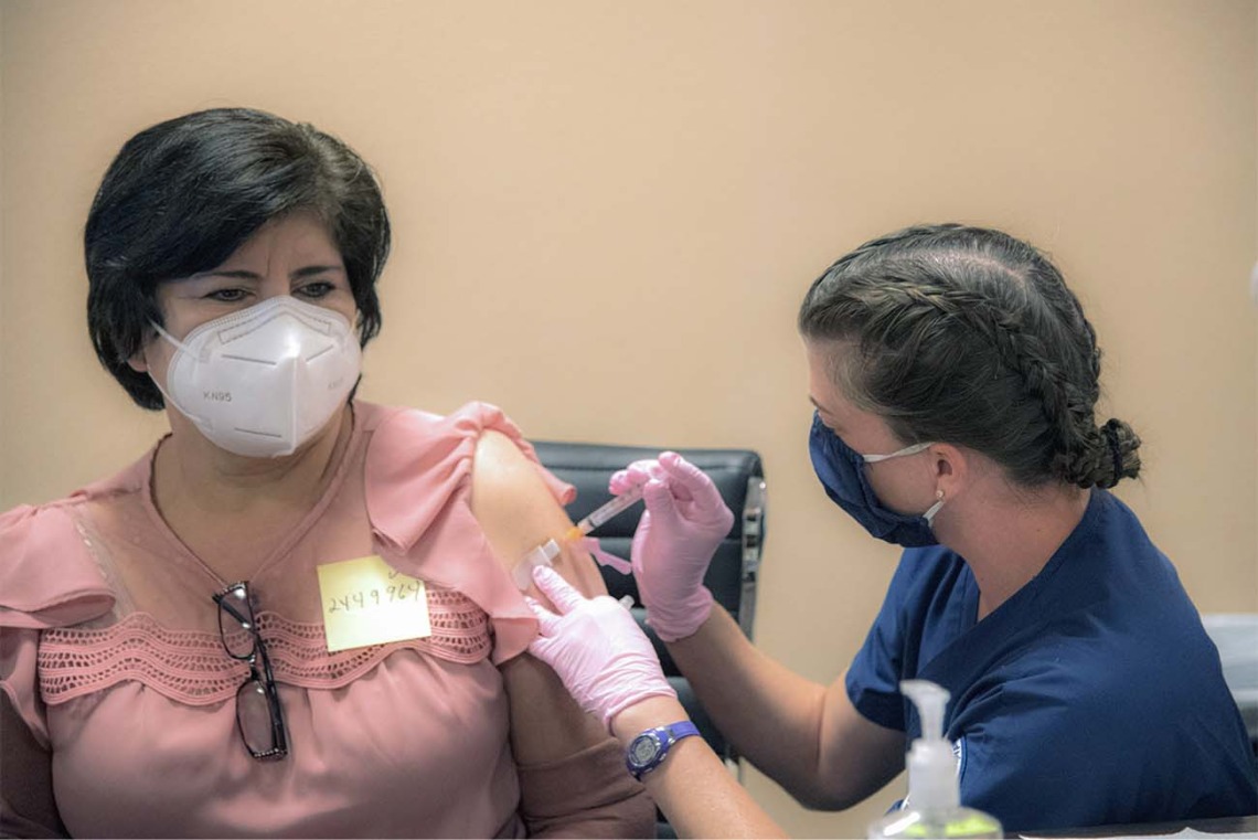 College of Nursing student Kathleen Gies vaccinates a patient at a MOVE UP COVID-19 clinic held by UArizona Health Sciences in Douglas, Ariz., in partnership with the Cochise County Health Department and Consulate of Mexico.
