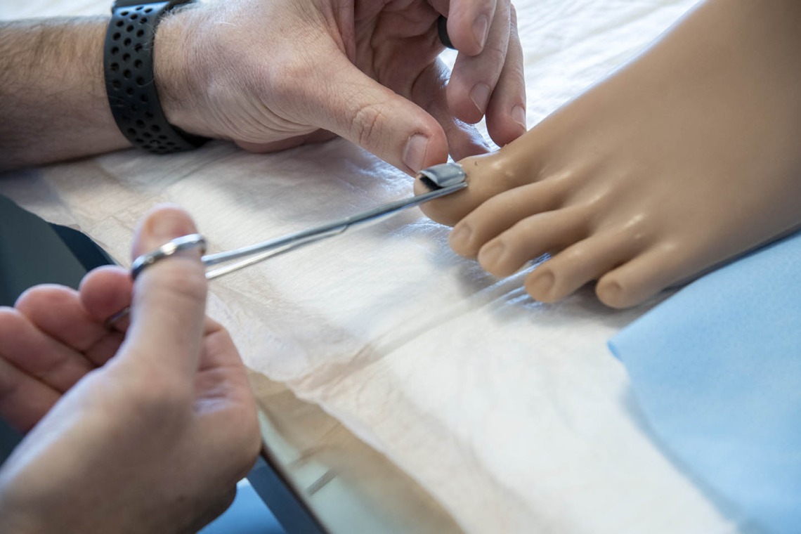 The College of Nursing uses lifelike manikins to practice removing toenails.