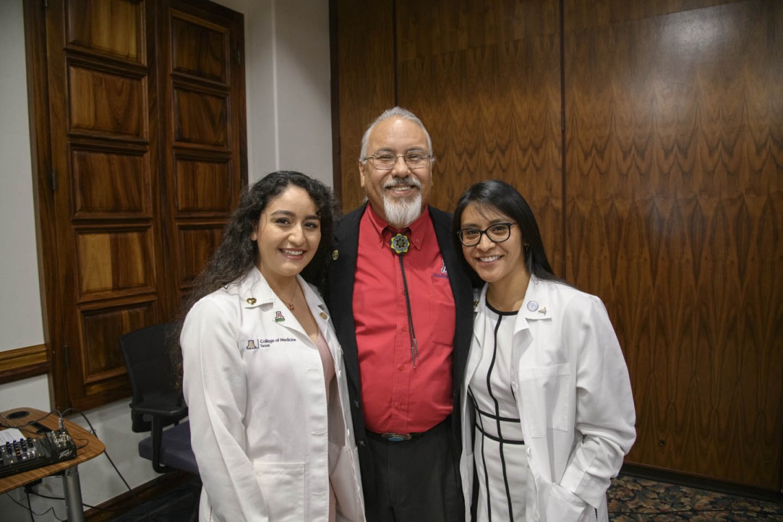 Primary Care Physician scholarship recipients Guadalupe Davila and Cazandra Zaragoza pose for a photo with Dr. Carlos Gonzales at the Tucson scholarship reception. 