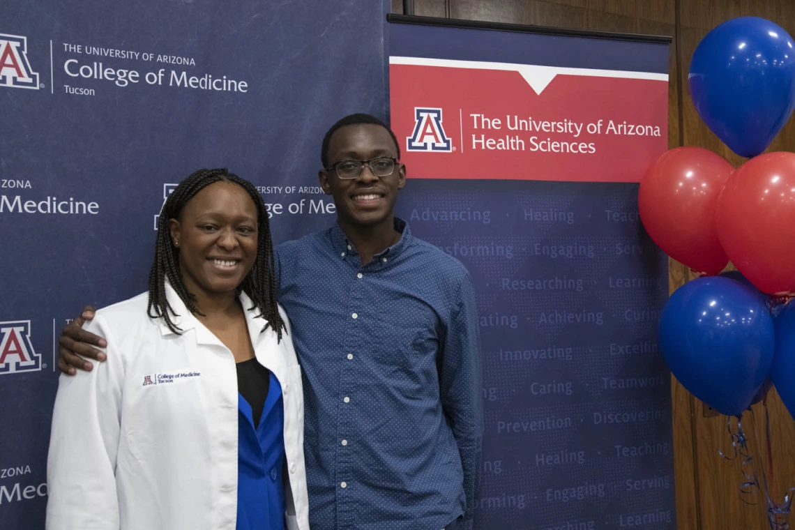 Primary Care Physican scholarship recipient Oumou Bah poses for a photo with her family. 