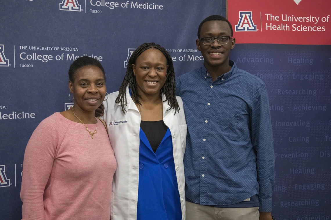 Primary Care Physican scholarship recipient Oumou Bah poses for a photo with her family. 