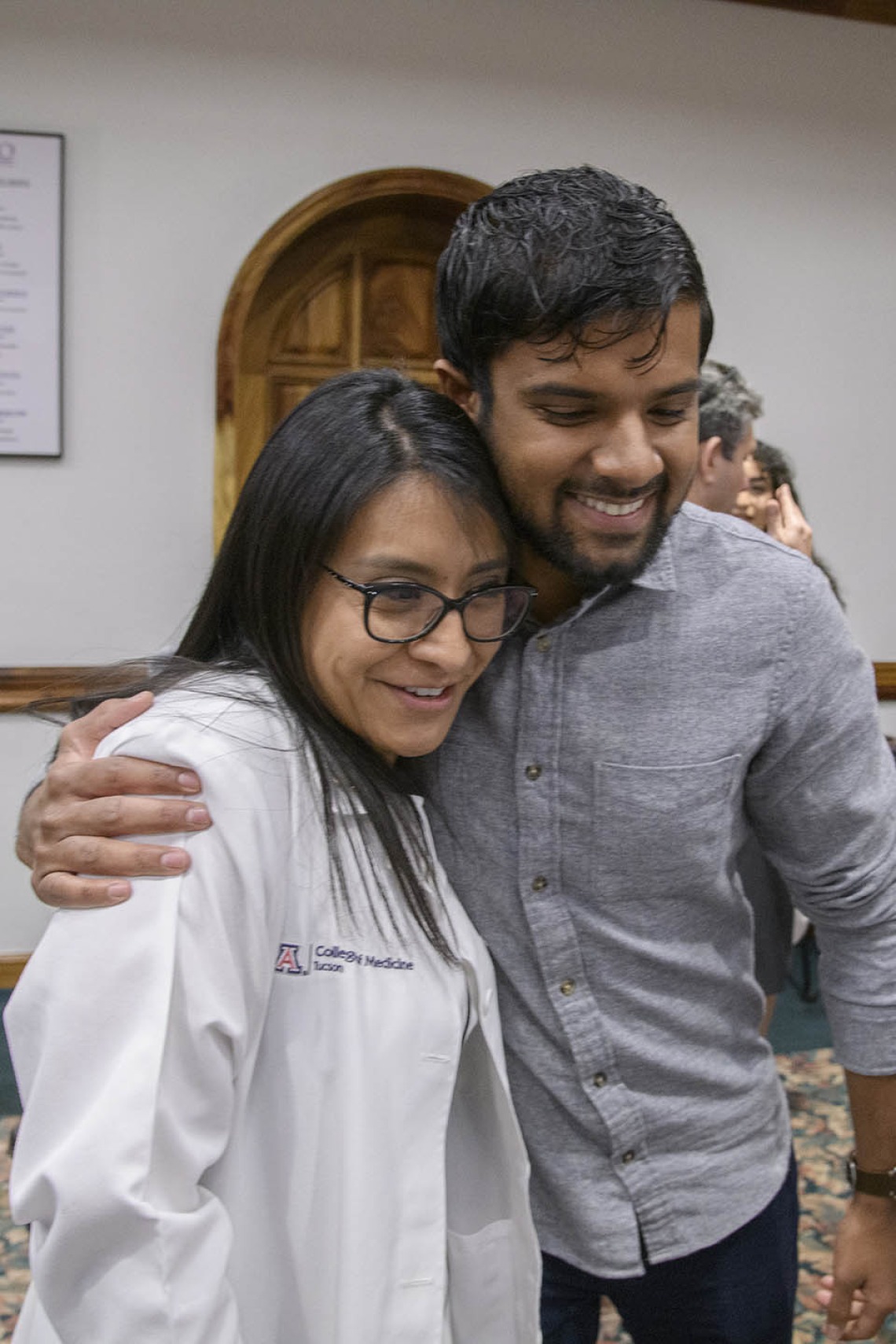 A friend hugs Cazandra Zaragoza after the Tucson Primary Care Physician scholarship reception. 