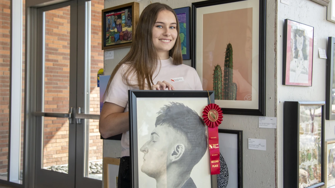 Winona Esher holds her artwork “Defined.” Esher’s UA affiliation is Melanie Esher-Blair, who works for the Department of Telemedicine.