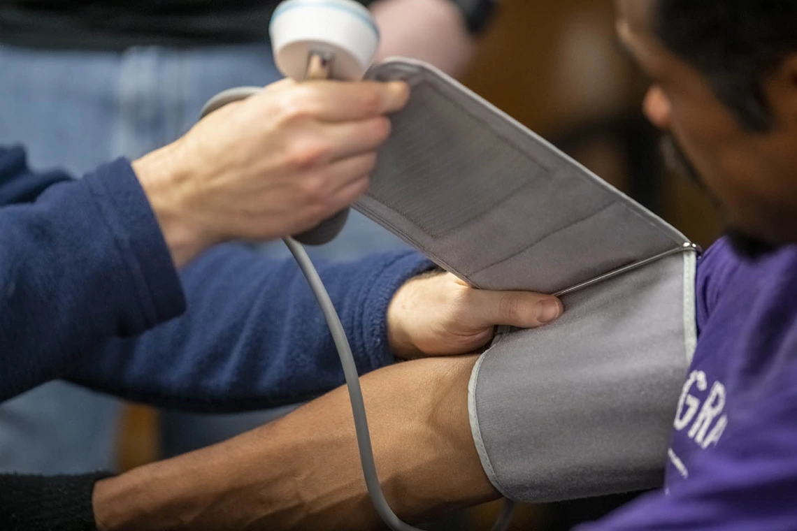 Street Medicine Phoenix co-founder Justin Zeien checks a patient’s blood pressure.