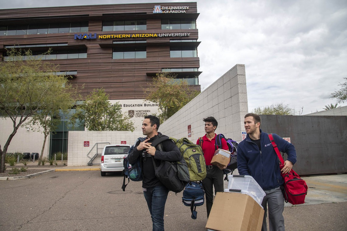 Co-founder Jeffery Hanna, left, student volunteer Eashan Das, center, and co-founder Justin Zeien, right, return supplies to the Street Medicine Phoenix storage area on College of Medicine – Phoenix campus after the Grace Lutheran Church street run.