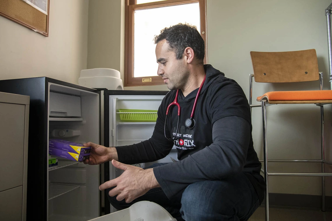 Street Medicine Phoenix co-founder Jeffery Hanna grabs vaccines from the fridge on campus before heading to Grace Lutheran Church for the February 23, 2020 street run.