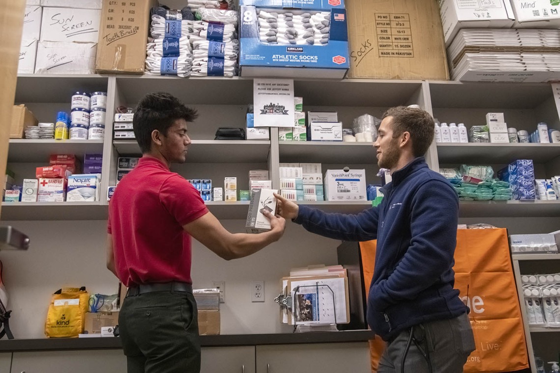 Student volunteer Eashan Das and co-founder Justin Zeien grab Street Medicine Phoenix supplies from the on-campus storage area for the February 23, 2020 street run at Grace Lutheran Church.