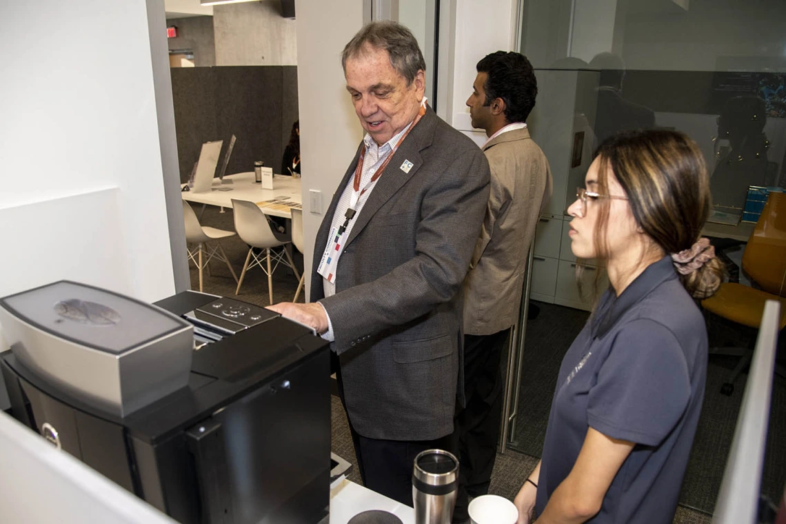 University of Arizona Senior Vice President of Health Sciences Michael D. Dake, MD, uses the new espresso machine inside the Faculty Commons + Advisory