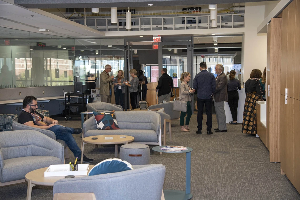 Attendees check out the new space during the grand opening of the Faculty Commons + Advisory event. 