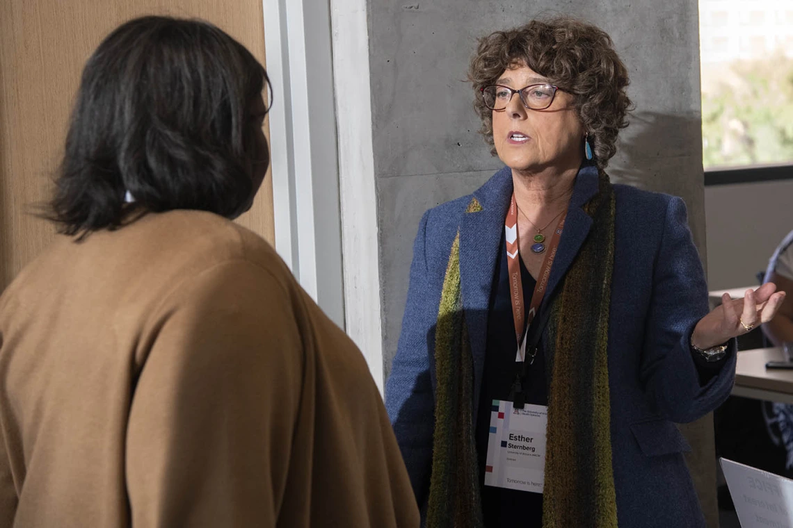 Taren Ellis Langford, JD, of the Conflict of Interest office, speaks to Esther Sternberg, MD, during the grand opening of the Faculty Commons + Advisory event inside the Health Science Innovation Building. 