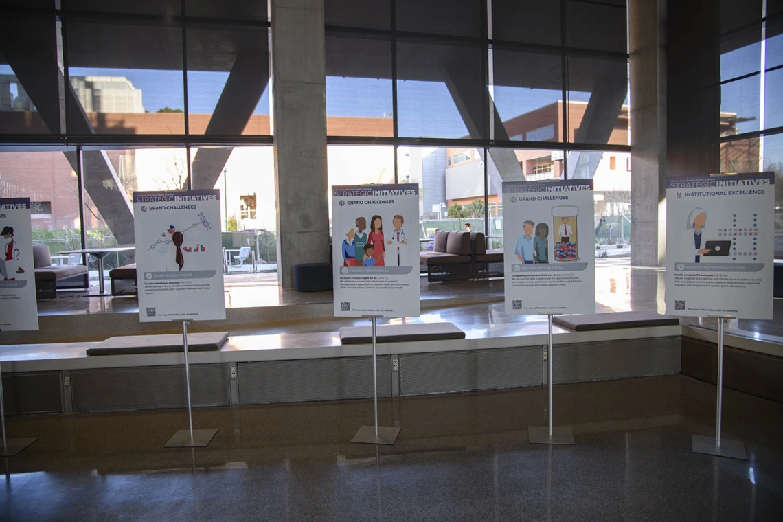 Health Sciences strategic initiatives posters decorate the lobby of the Health Sciences Innovation Building at the town hall event in the Forum, Jan. 28, 2020.