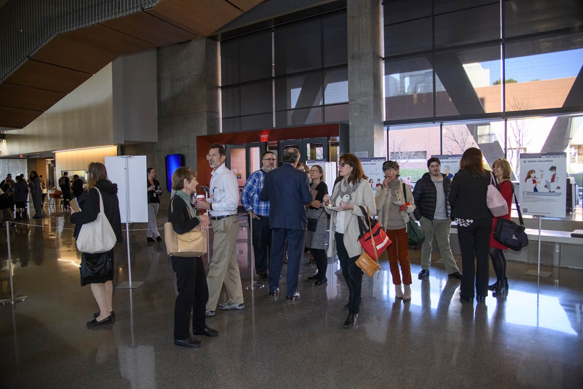 Attendees mingle inside the Health Sciences Innovation Building after the town hall event, Jan. 28, 2020. 