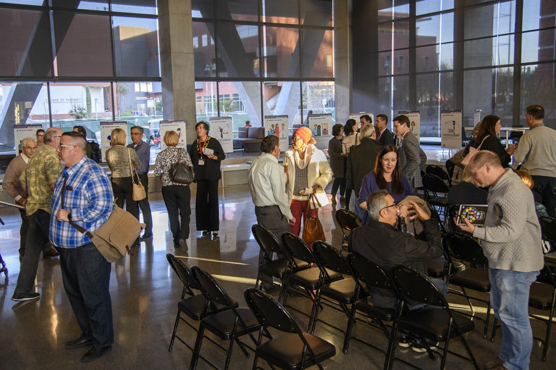 Attendees mingle inside the Health Sciences Innovation Building after the town hall event, Jan. 28, 2020. 