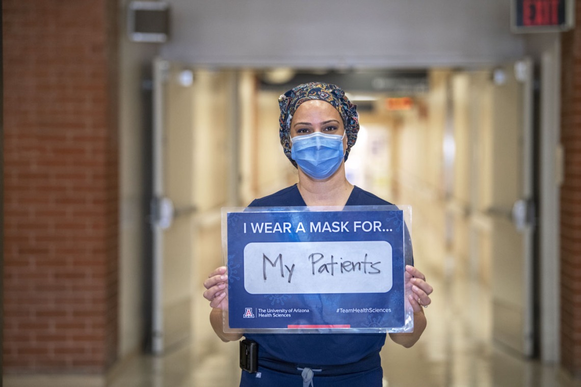 Indu Partha, MD, assistant professor at the College of Medicine – Tucson, wears a mask for her patients.
