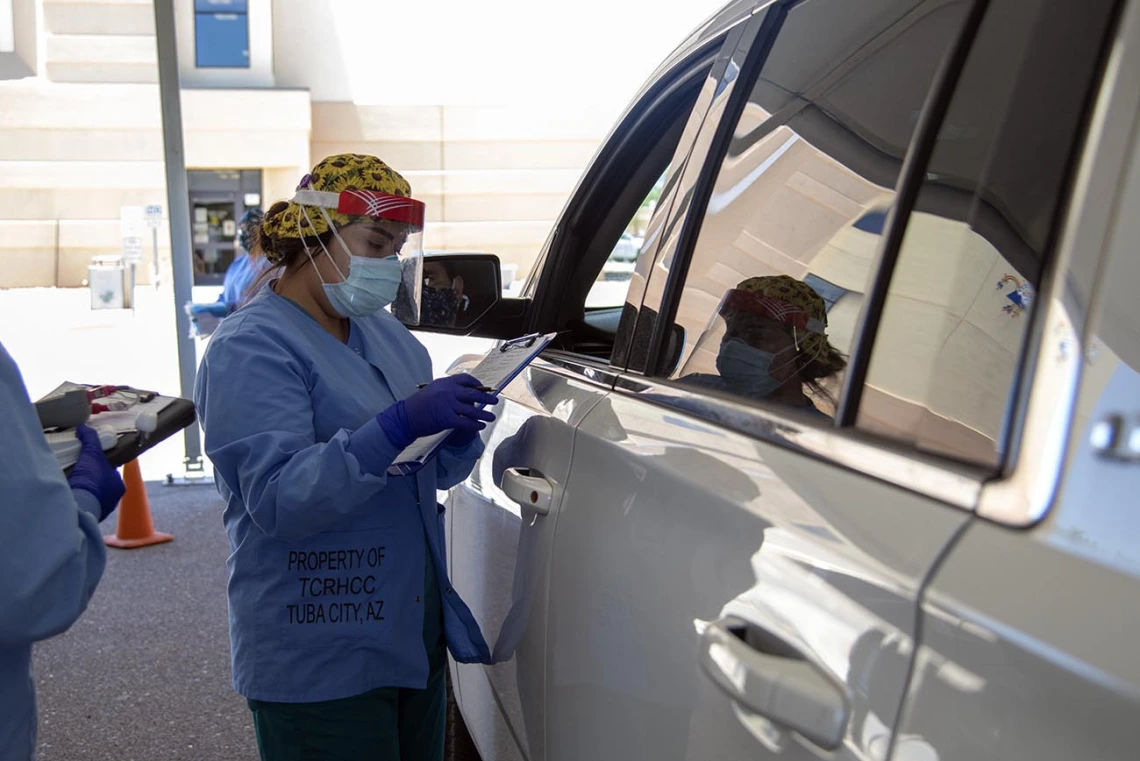 A Tuba City Regional Health Care employee speaks with a person seeking COVID-19 testing. 