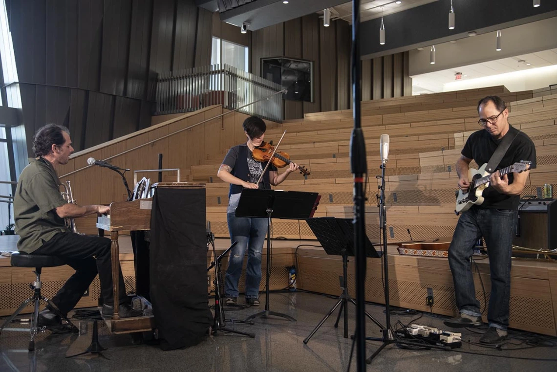 Two-Door Hatchback performs in the University of Arizona Health Sciences Innovation Building for The Tucson Studio. The band includes Samantha Bounkeua and brothers Marco (right) and Dante Rosano (left).