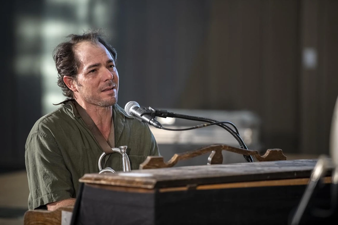 Dante Rosano of Two-Door Hatchback plays the piano during a performance in the Forum in the Health Sciences Innovation Building. 