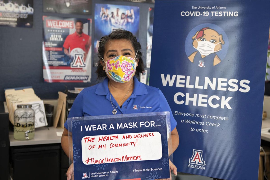 Alma Ramirez, a health educator  from the Mel and Enid Zuckerman College of Public Health’s Phoenix campus, holds a sign that reads, “I wear a mask for the health and wellness of my community.”