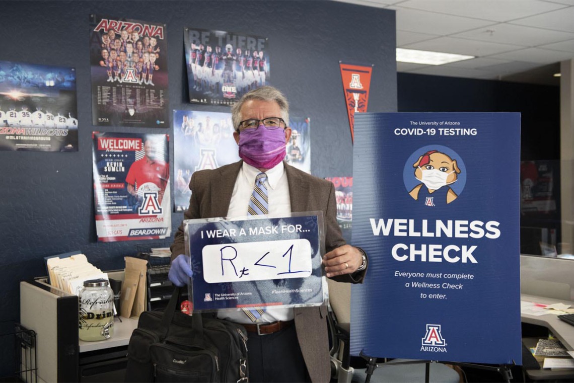 Terry Urbine, PhD, assistant professor at the University of Arizona Mel and Enid Zuckerman College of Public Health’s Phoenix campus, shares his sign, showing that wearing masks can bring the R number of the virus that causes COVID-19 below 1. This number measures the average number of people someone shedding the virus will infect.