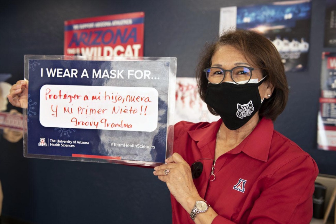 Cecilia Rosales, MD, MS, wears a mask to protect her first newborn grandchild. Dr. Rosales is an associate dean, professor and chair of the Division of Public Health Practice & Translational Research at the Mel and Enid Zuckerman College of Public Health on the Phoenix Biomedical Campus. 
