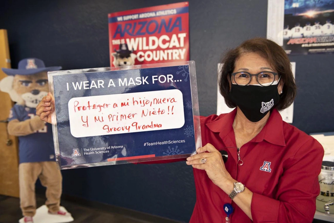 Cecilia Rosales, MD, MS, associate dean, Phoenix Campus, shares that she wears a mask to protect her first newborn grandchild during the COVID-19 pandemic in 2020. 