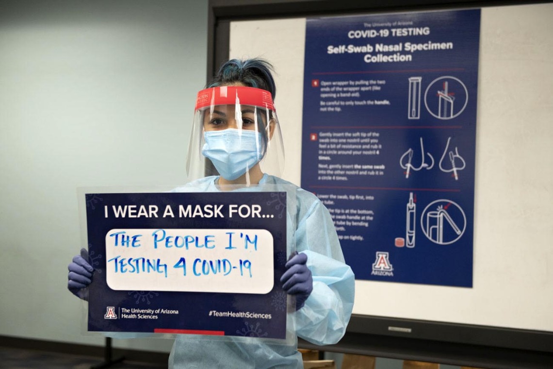 Taking a break from her work testing the UArizona community on the Phoenix campus, Shannon Espinosa, RN, UArizona alumni, says she wears a mask “for the people I’m testing for COVID-19.”