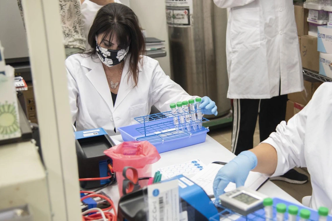 Lab tech Jennifer Alvarado places a cassette into the machine and waits 11 seconds for a result. 