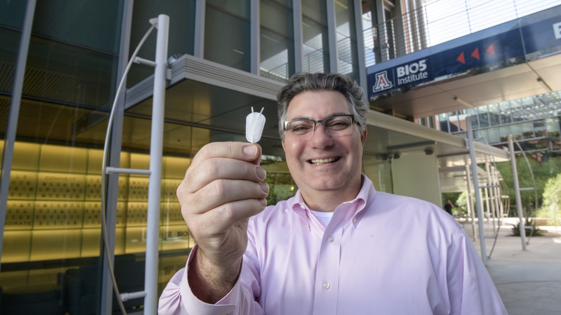 Klearchos Papas, PhD, director of the College of Medicine – Tucson’s Institute for Cellular Transplantation, holds a synthetic nanoporous pouch used in an implantable cell therapy device to provide insulin for Type 1 diabetes patients.