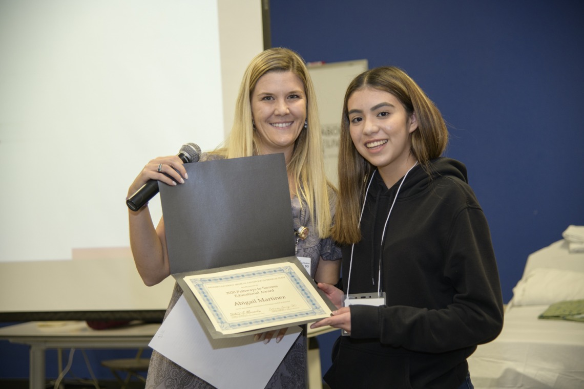 Abigail Martinez from Sunnyside High School receives a scholarship from a Banner representative.