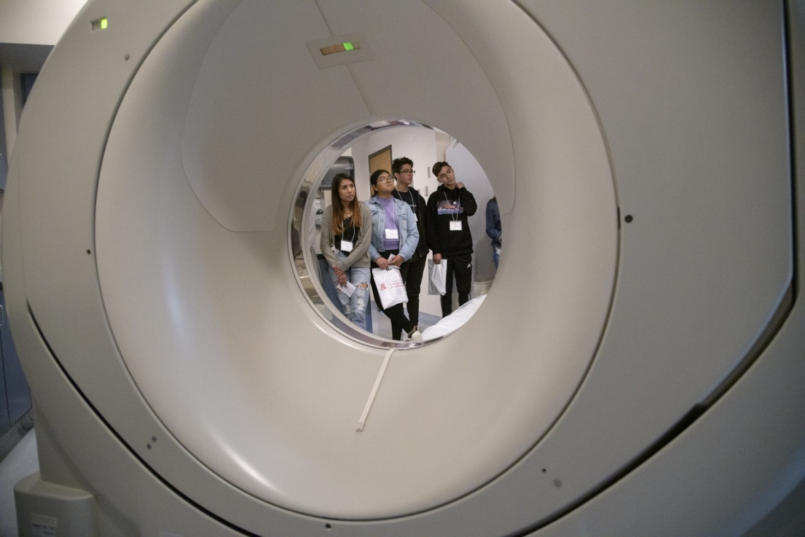 High school students touring Banner – University Medical Center South visit the CT scanner room.