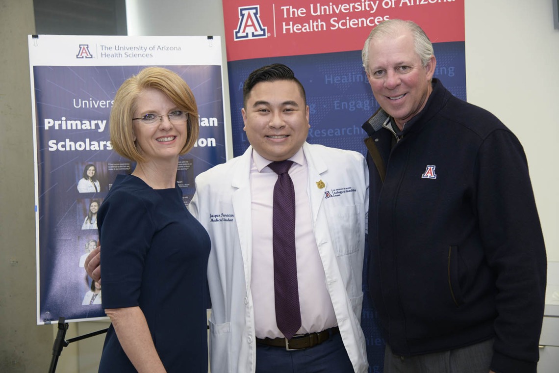 Rep. Heather Carter, Primary Care Physician scholarship recipient Jasper Puracan and University of Arizona President Robert C. Robbins, MD, pose for a photo.