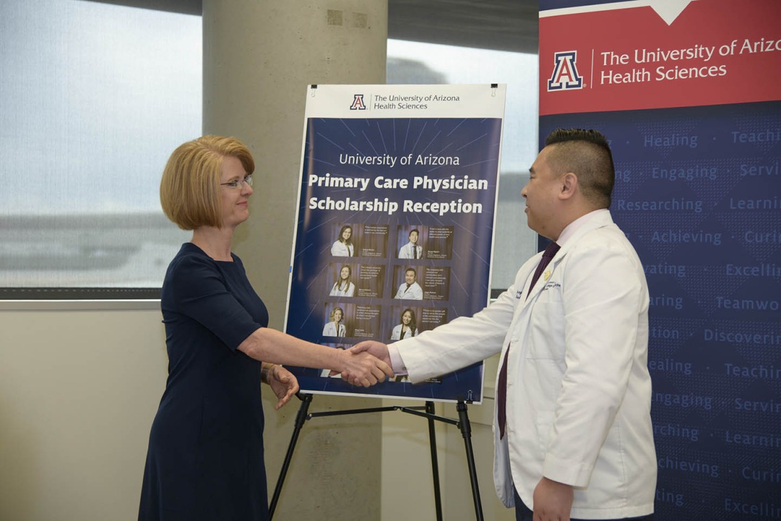 Rep. Heather Carter shakes hands with  Primary Care Physician scholarship recipient Jasper Puracan. 