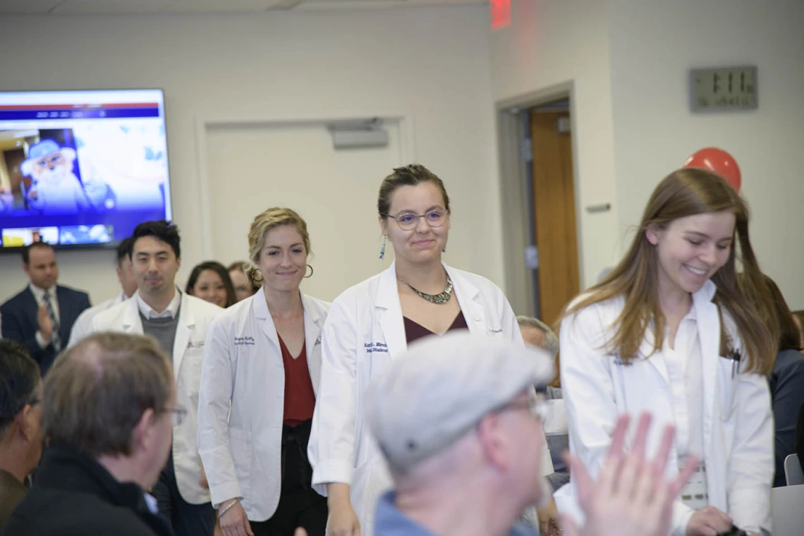 Primary Care Physician scholarship recipients walk in for the start of the reception. 