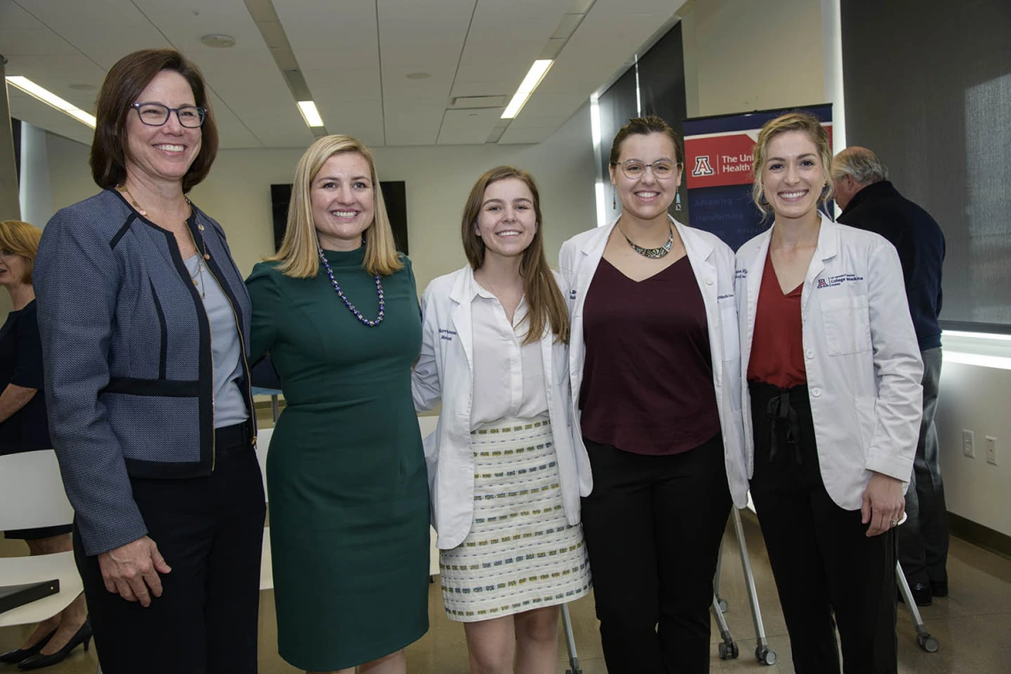 Primary Care Physician scholarship recipients Merrion Dawson, Kathryn Blevins and Megan Kelly pose for a photo after the reception with attendees. 