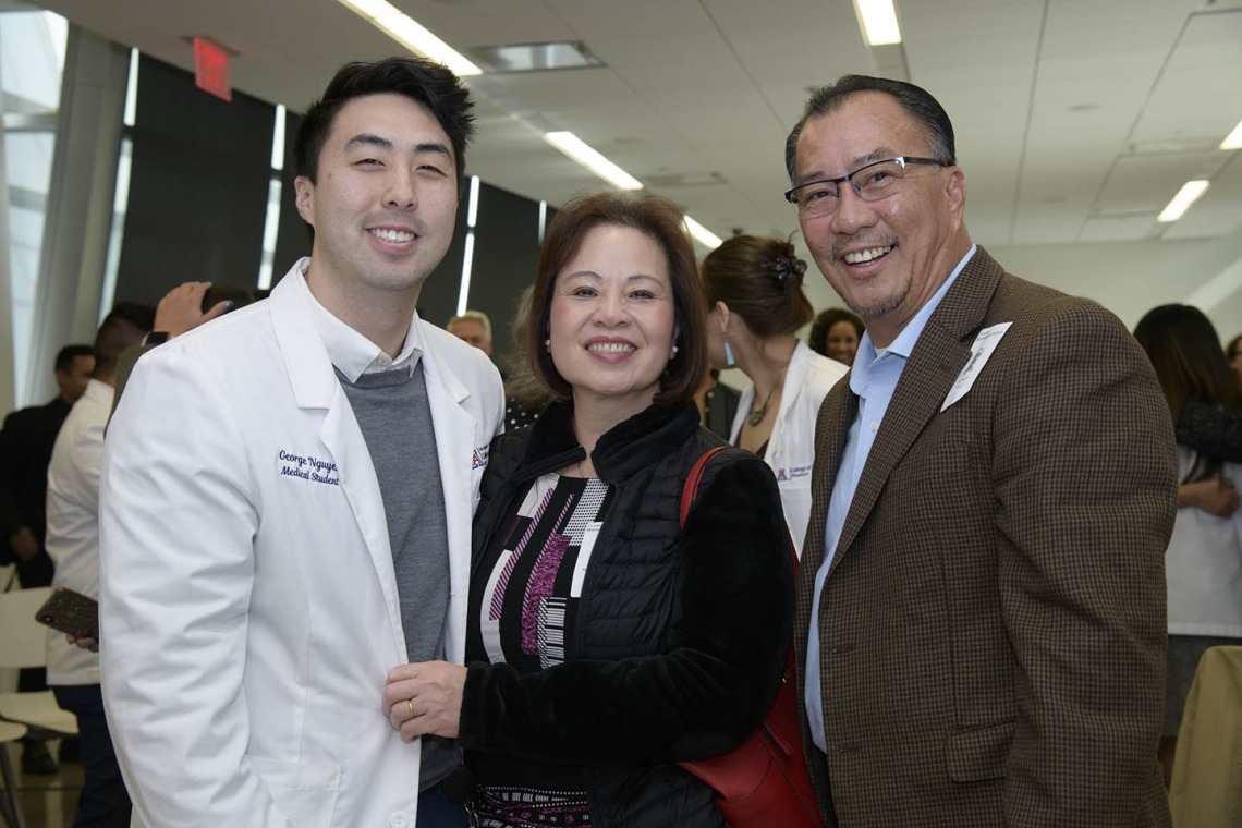 Primary Care Physician scholarship recipient George Nguyen poses for a photo with his family. 
