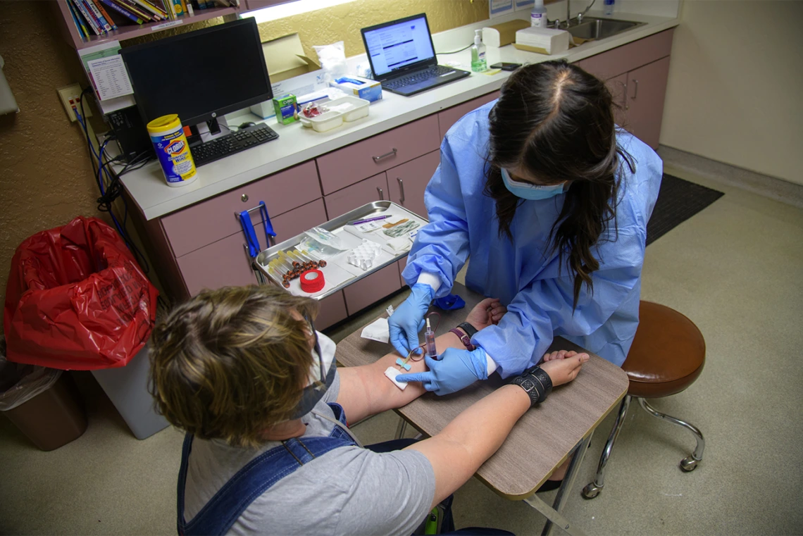 Stephanie Morales draws blood from Emily Jean Krull for a COVID-19 antibody test at the Pima County Health Department in early May.