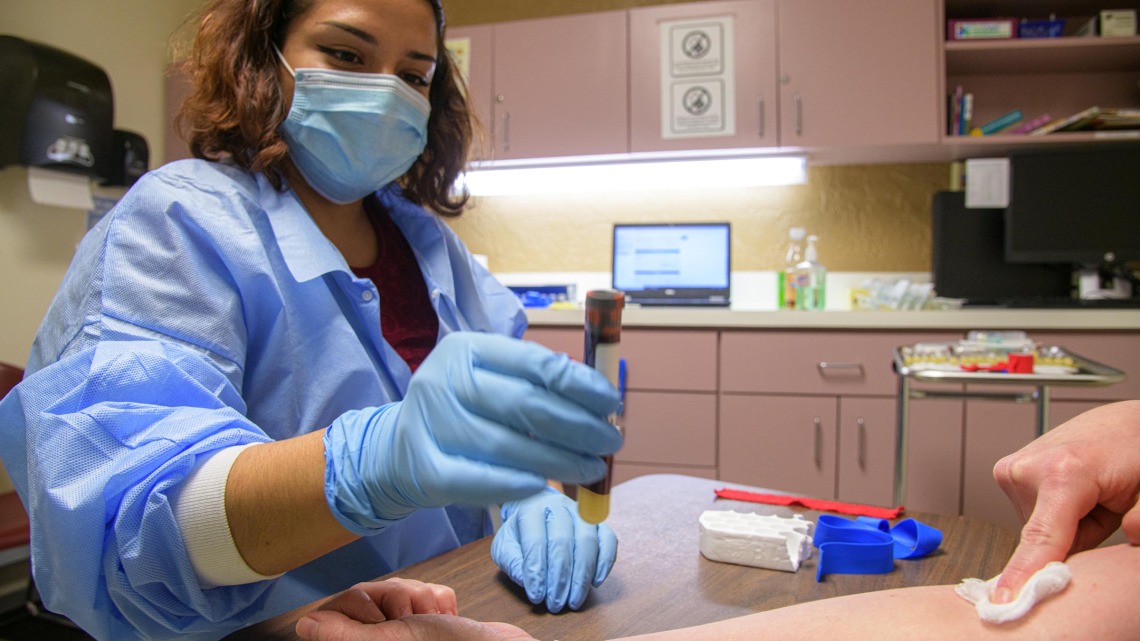 Emely Mancia-Chavez, clinical research coordinator for the All of Us research program, performed a blood draw for a COVID-19 antibody test during the pilot phase of the program in Pima County.