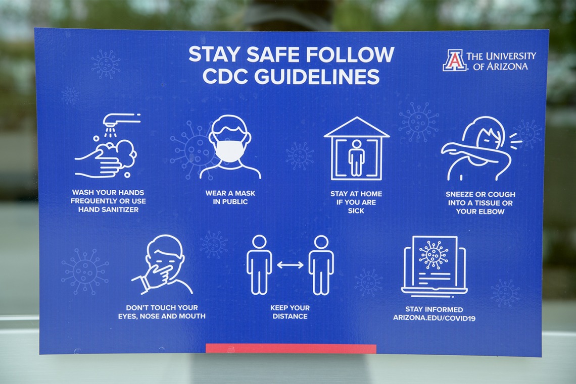 Signage reminding passersby to follow CDC safety guidelines. 