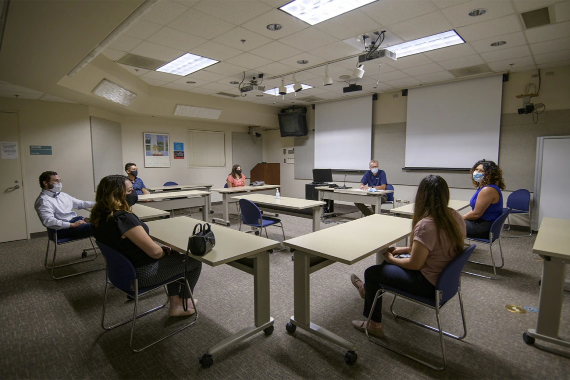 Conference rooms fit fewer people to allow for adequate physical distancing. Here, incoming first-year College of Medicine – Tucson students meet with their house dean, George Fantry, MD.