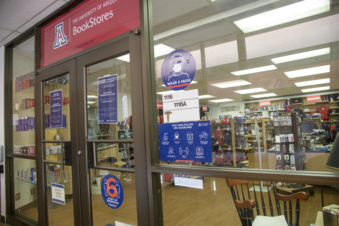 Signage outside of the UArizona Medical Bookstore encourages students to follow proper safety precautions.