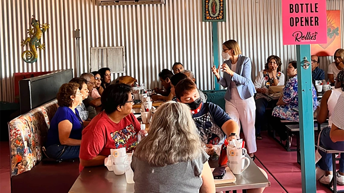 Cancer Center Director Joann Sweasy, PhD, (right) speaks to the public at Rollies Mexican Patio in Tucson at the first of the center’s scientific cafes. 